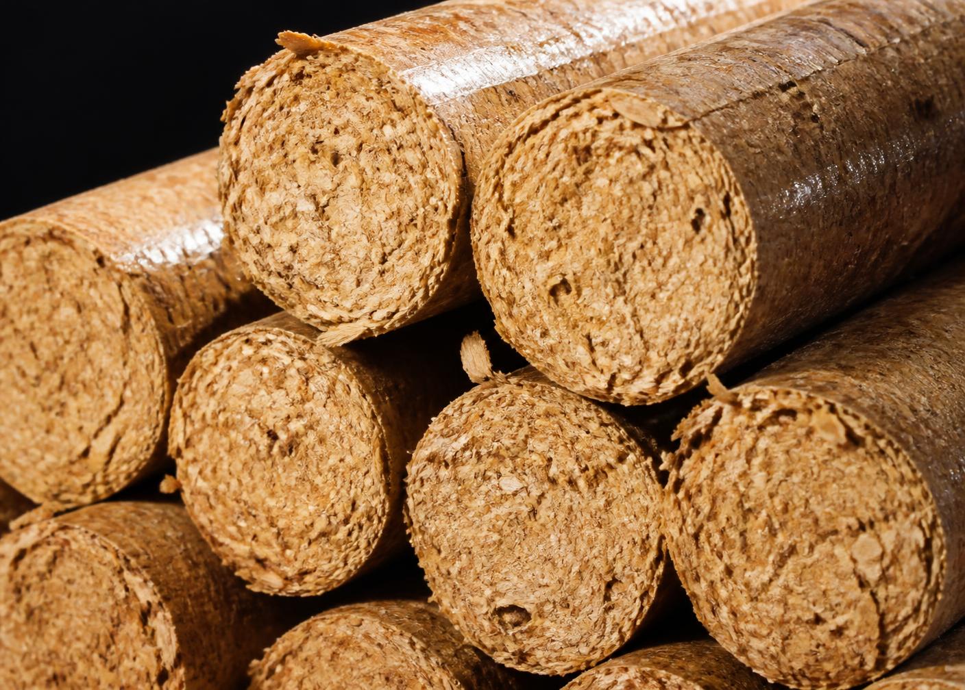 High-density sawdust biomass briquettes stacked